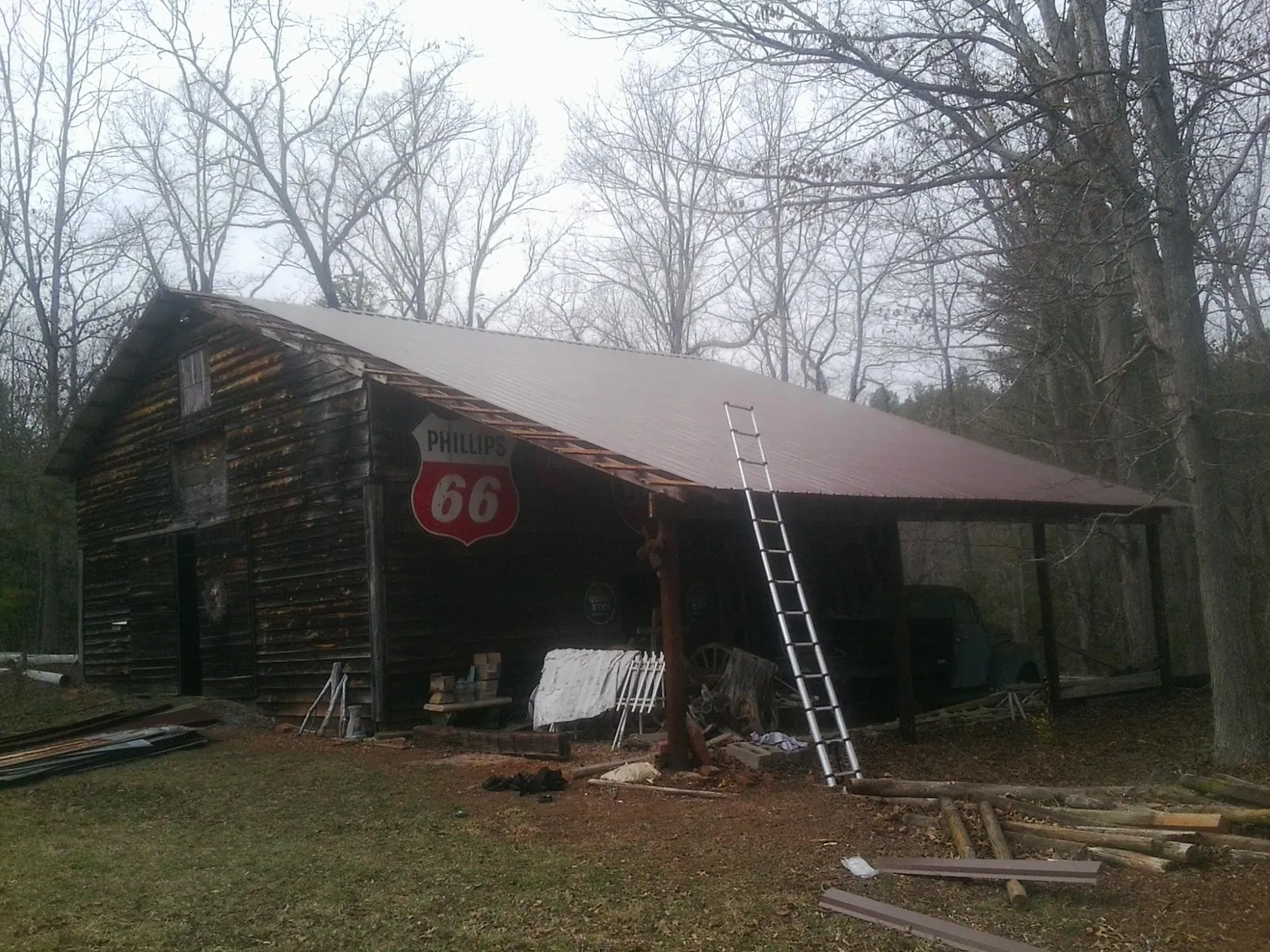 New metal roof on an open sided timber barn with a vintage sign in Kasson